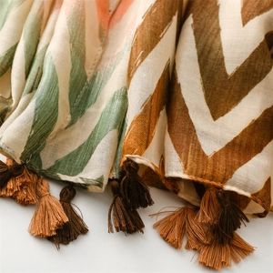 Detailed macro view of woven chevron pattern and fringed tassels on cotton linen scarf