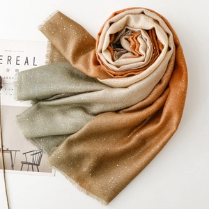 Detail of gradient cotton linen scarf with gold foil dots and natural frayed edges