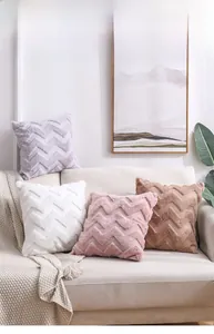 Close-up of plush decorative pillows with chevron textured faux fur on a cozy sofa