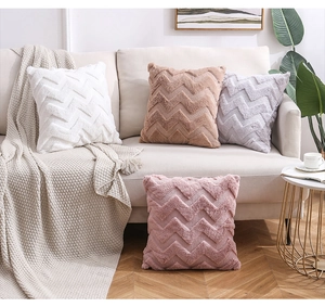 Close-up of plush decorative pillowcases with luxury faux fur and wavy textured pattern