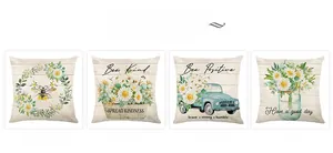 Detailed view of four farmhouse throw pillow covers with bee and floral truck prints