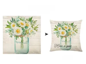 Detail of floral pillow case with daisies in a jar on wood background texture