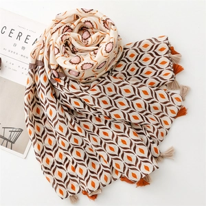 Detail of geometric diamond pattern scarf with tassels next to Cereal magazine