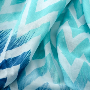 Macro shot of blue wave pattern scarf with breathable cotton-linen texture and tassels