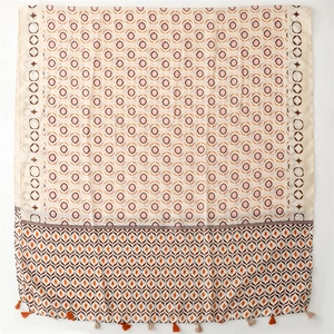 Detail of vintage floral pattern scarf with tassel edges and soft silk-like texture