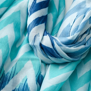 Detailed texture of blue chevron wave pattern on lightweight cotton linen scarf with tassels