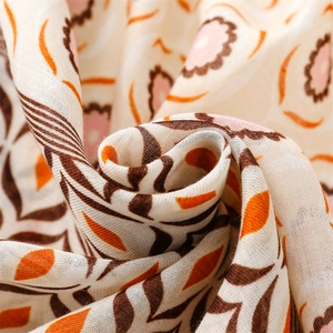 Detailed macro view of ethnic floral scarf fabric with cotton linen texture and fringe