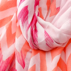 Detail of pink and orange chevron scarf with soft linen texture and stitched edges