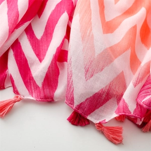 Detail of pink and orange wavy pattern scarf with delicate handmade fringe edges