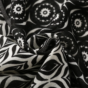 Detailed macro view of black and white mandala geometric pattern on soft cotton scarf