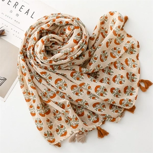 Detail of vintage floral pattern and soft tassels on a linen feel summer scarf