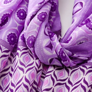 Detailed macro view of purple floral and geometric patterns on a lightweight linen-feel scarf