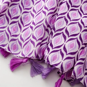 Detail of purple geometric patterns and fringe tassels on soft cotton-linen feel scarf