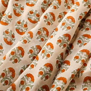 Detail shot of breathable cotton linen scarf featuring vibrant orange floral pattern prints