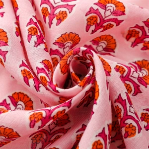 Macro detail of pink floral linen scarf texture with soft fringe and ethnic pattern