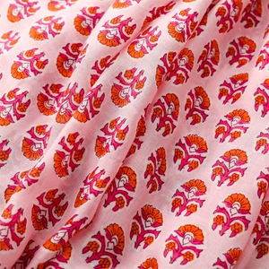 Detailed close-up of pink linen-feel scarf with floral patterns and soft fabric texture