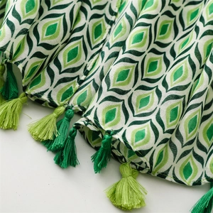 Detailed view of geometric star moon pattern with fringe tassels on cotton linen shawl