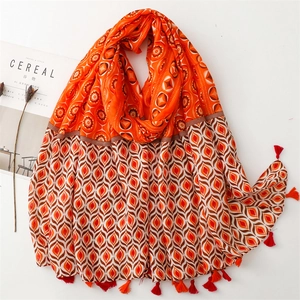Detail of bohemian printed scarf with ethnic patterns and soft fringe tassels