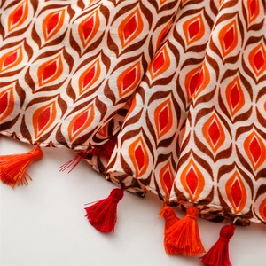 Close-up of geometric pattern cotton scarf with bohemian style red and orange fringe