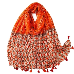 Boho style orange scarf with geometric mandala patterns and decorative fringe tassels