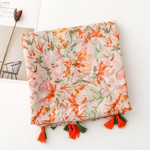 Close-up of lightweight floral shawl with vibrant tassels and artistic print design