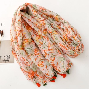 Close-up of floral pattern scarf featuring soft tassels and lightweight fabric texture