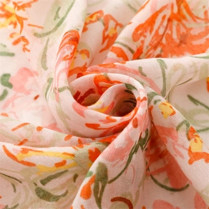 Detail of floral printed voile scarf showing soft fabric texture and red flower patterns