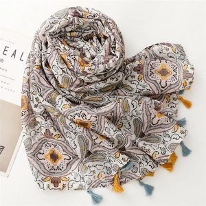 Detailed shot of ethnic print scarf with soft tassels and geometric patterns on beige base