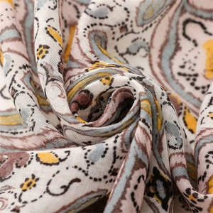 Detailed close-up of paisley pattern on a lightweight linen-texture travel shawl