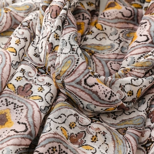 Close-up of retro paisley pattern on soft Bali yarn shawl with elegant draped texture