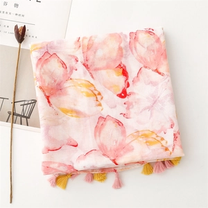 Detail of pink butterfly print scarf with soft pastel gradients and handmade fringe tassels