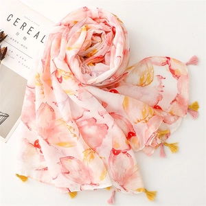 Close-up of lightweight chiffon scarf with ink butterfly print and yellow-pink tassels