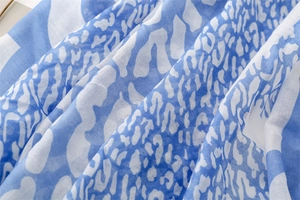 Close-up detail of blue leopard print on lightweight breathable cotton linen scarf