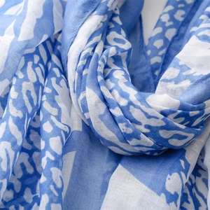 Detail of blue and white leopard print scarf in lightweight linen-feel fabric