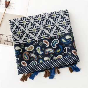 Detail of vintage bohemian scarf with paisley patterns, tassels, and artistic props