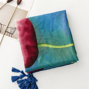 Detail of floral voile scarf with blue silk tassels and artistic watercolor ink flower prints