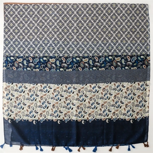 Detail view of ethnic paisley and geometric print scarf with decorative fringe tassels