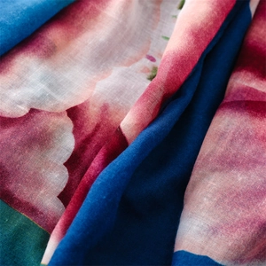 Close-up of ink wash floral print on lightweight voile scarf with visible weave texture