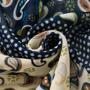 Close-up of vintage paisley and polka dot printed fabric with woven texture