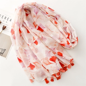 Lightweight white scarf with orange and purple ginkgo leaf patterns and fringe trim