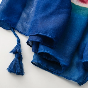 Detailed view of lightweight royal blue shawl with tassels and ethnic floral patterns