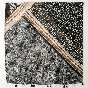 Close-up of leopard print and floral patchwork scarf with mini fringe edge detail