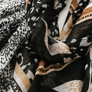 Detailed view of the leopard print and geometric pattern on the soft cotton scarf fabric