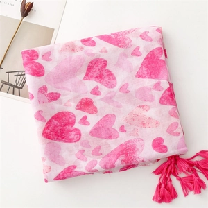 Detailed view of pink heart print linen-feel scarf with elegant fringe tassels on edges