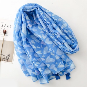 Detailed view of light blue heart print scarf with decorative fringe and fringe edges