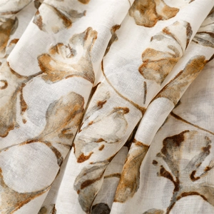 Detail of breathable linen-feel scarf with ginkgo leaf patterns and natural texture