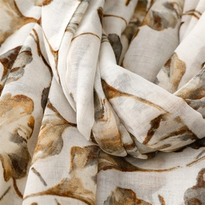 Macro detail of breathable ginkgo leaf print on soft white summer scarf fabric