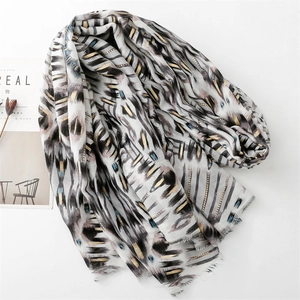 Detail of colorful geometric cotton linen scarf with gold foil accents and fringe edges