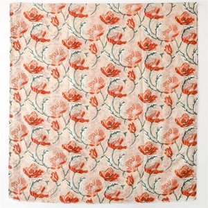 Detail of pink cotton-linen scarf featuring red poppy flower prints and frayed edges