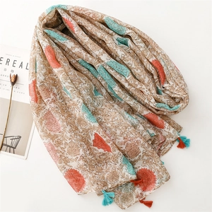 Detail of vintage floral print scarf with elegant tassels and breathable voile fabric